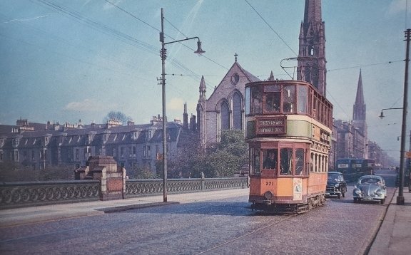 A great image for today's #ArchiveTravel theme. Photo of tram car 271 crossing Kelvinbridge near <a href="/GlasgowSubway/">GlasgowSubway</a> in 1956 with Lansdowne Parish Church by John Honeyman (<a href="/WebstersTheatre/">Websters Theatre</a>) &amp; St Mary's Cathedral in the background. #Archive30