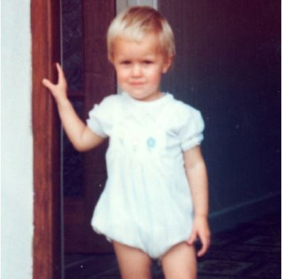 'There is a photograph of me as a toddler in a white, cotton romper, standing on my own in the doorway, in our first family home.... I looked like such a typical toddler, but Mum remembered worrying that I wasn’t going to walk.' Excerpt from Knowing No Boundaries by Hannah Daly.