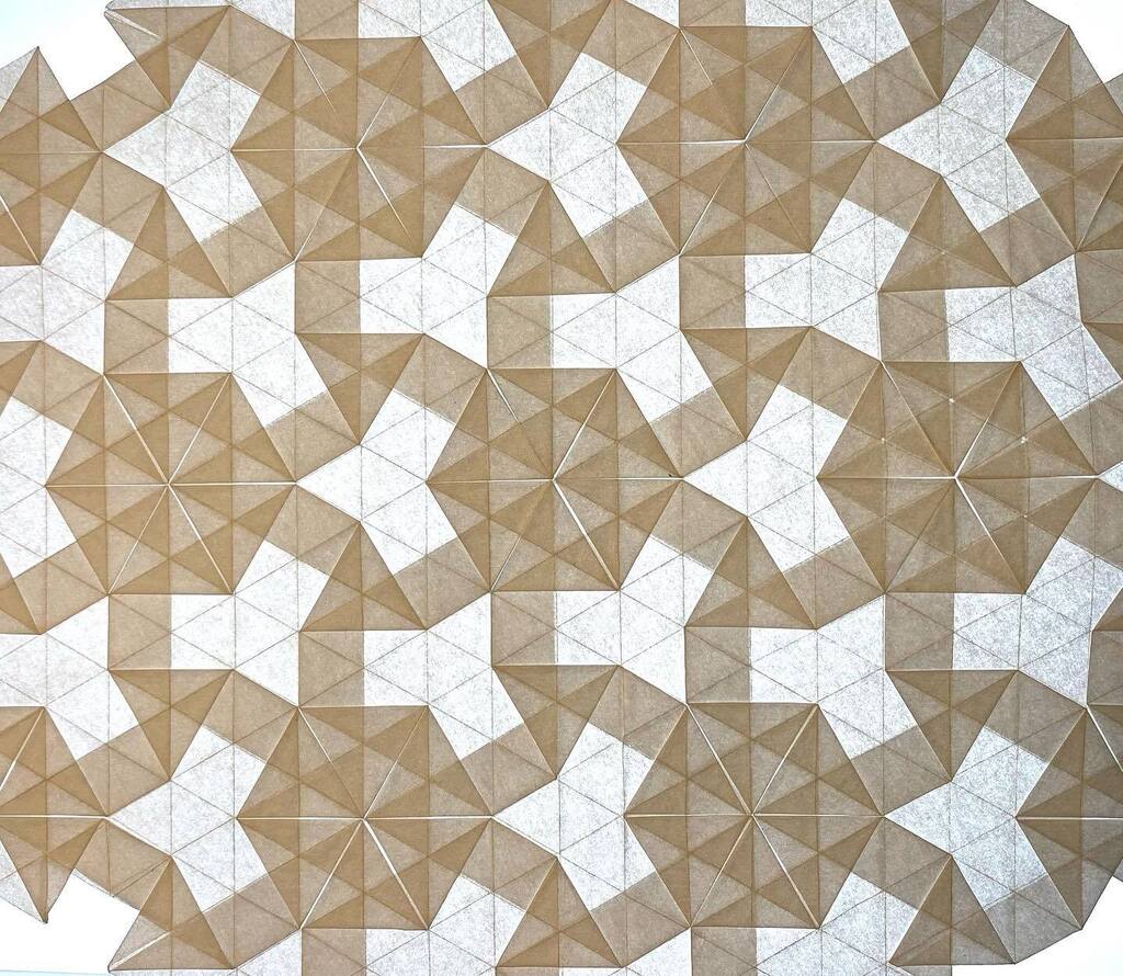 origamitraces's tweet photo. Baking paper gives such a nice effect!
This tessellation-pattern has been folded by many, I'm sure. But in my case, I was just playing around. 
I love the fact that the V-shaped 'empty' parts seem almost random if you don't look carefully. They are not a… https://t.co/hGRMtmaGRs https://t.co/2M0mI5sldK