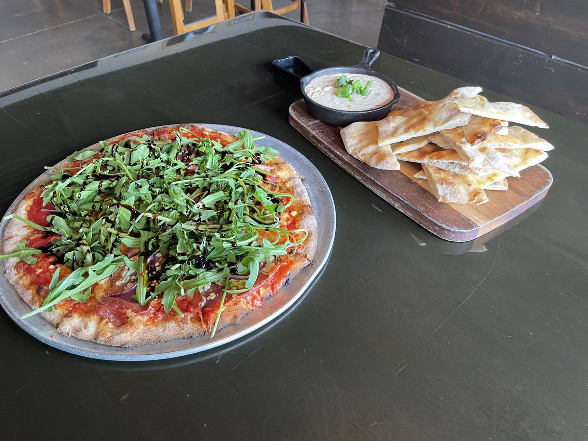 JeremyMillsop's tweet photo. The Local along with a side of “S!$T”on a shingle  at Dough Bros. In Baxter. I love the crust and the Woodfire cook gives the pizza a ton of flavor. Prosciutto, red onion, goat cheese, basil, red sauce, arugula and a balsamic reduction top the crust. #DispatchDiningGuide2023 https://t.co/hgAUcuiOBi