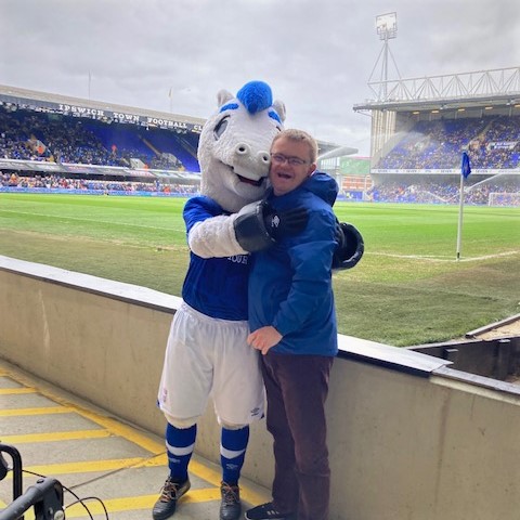 LeadingLives's tweet photo. One of our #SupportToLiveAtHome customers enjoyed a day out attending an @IpswichTown match with a special visit from Town mascot Bluey! He enjoyed the game and said "It made me very happy, especially meeting Bluey and Ipswich winning!" #SocialCare #LeadTheLifeYouChoose #ITFC https://t.co/NJT71J2i6t