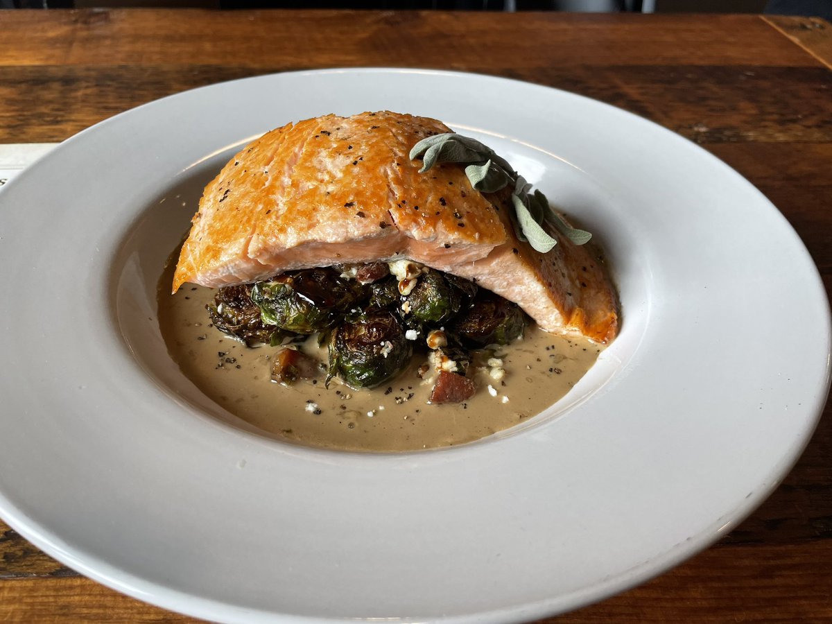 JeremyMillsop's tweet photo. Peppercorn salmon with fried Brussel sprouts, balsamic glaze, bacon and feta cheese. That’s a beautiful piece of fish on top of goodness. Main Street Ale House in downtown Nisswa. So good #DispatchDiningGuide2023 @brd_dispatch https://t.co/3emZ3Dpo4e