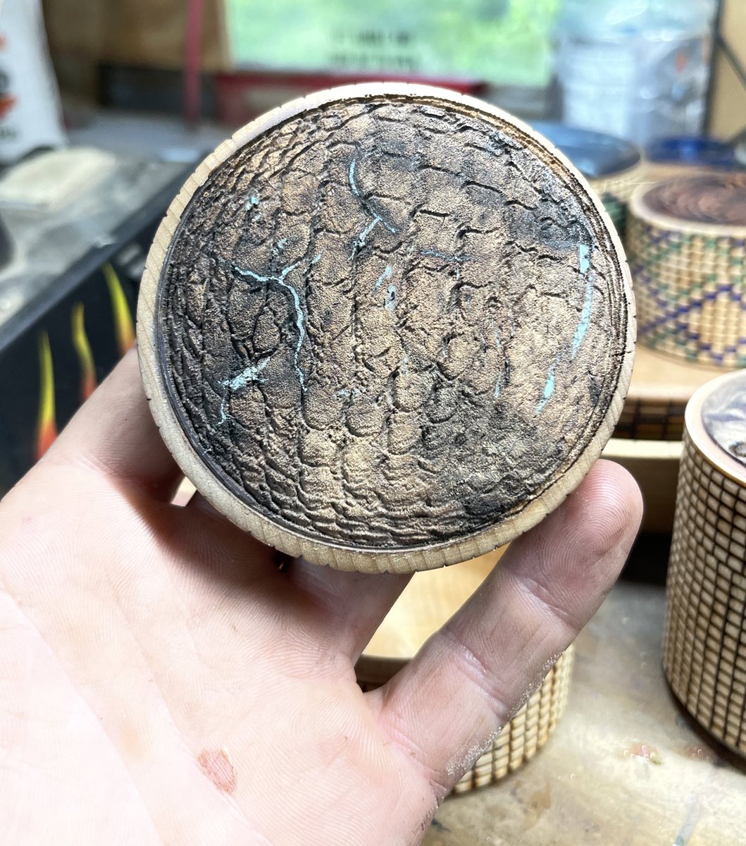 This is wood textured with a laser to look and feel like dragon scales. The light colors are turquoise. It’s pretty damn cool in my opinion.