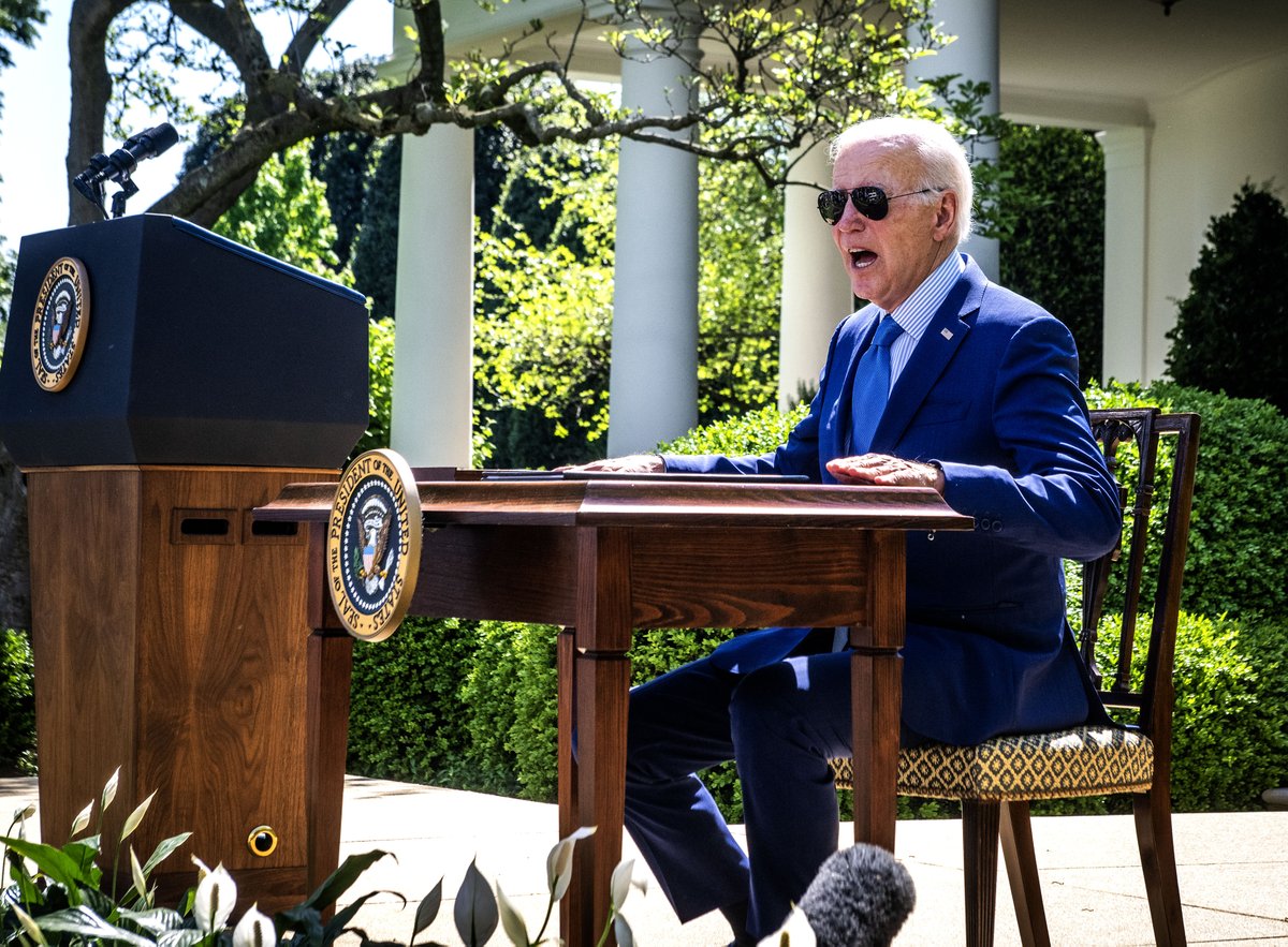 President Joe Biden reacts to the heat of a table that has been in the sun a he sits down to sign an executive order on new actions to advance environmental justice during a ceremony in the Rose Garden at the White House, in Washington, DC. Washington Post photo/Bill O'Leary