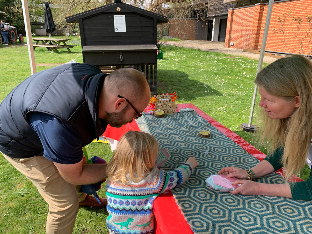 Family playing the bee game in the MERL garden