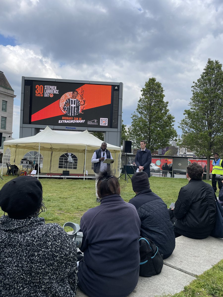 Royal_Greenwich's tweet photo. Cllr @MrOkereke is addressing the community at our #StephenLawrenceDay event: 
“By continuing to share his story with the young people of our borough, we can motivate a new generation to drive forward the changes we still need to see in our society.”   
#SLD30 #BecauseofStephen https://t.co/UTmtAVVhc7