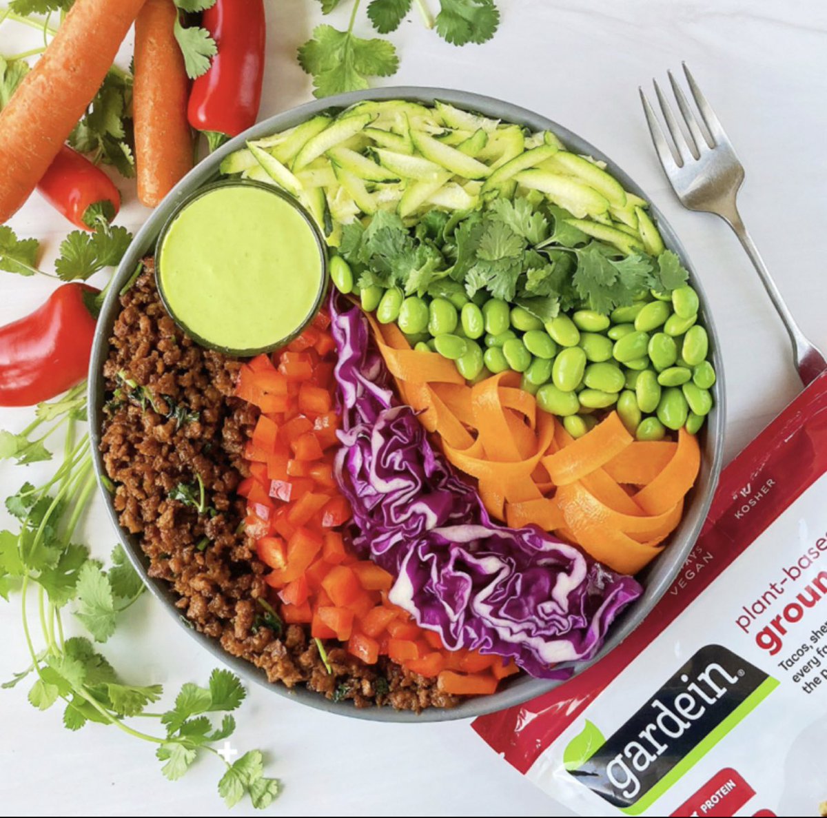 gardein's tweet image. Happy #EarthDay 🌱🌍 Celebrate with this colorful, flavor-packed bowl that our friend @clairebear_bites created for us with our #Plantbased Ground Be'f, red bell peppers, red cabbage, carrots, edamame, cilantro, zucchini, and a wasabi dressing. 🫶🏼 #Vegan #Flexitarian #Vegetarian