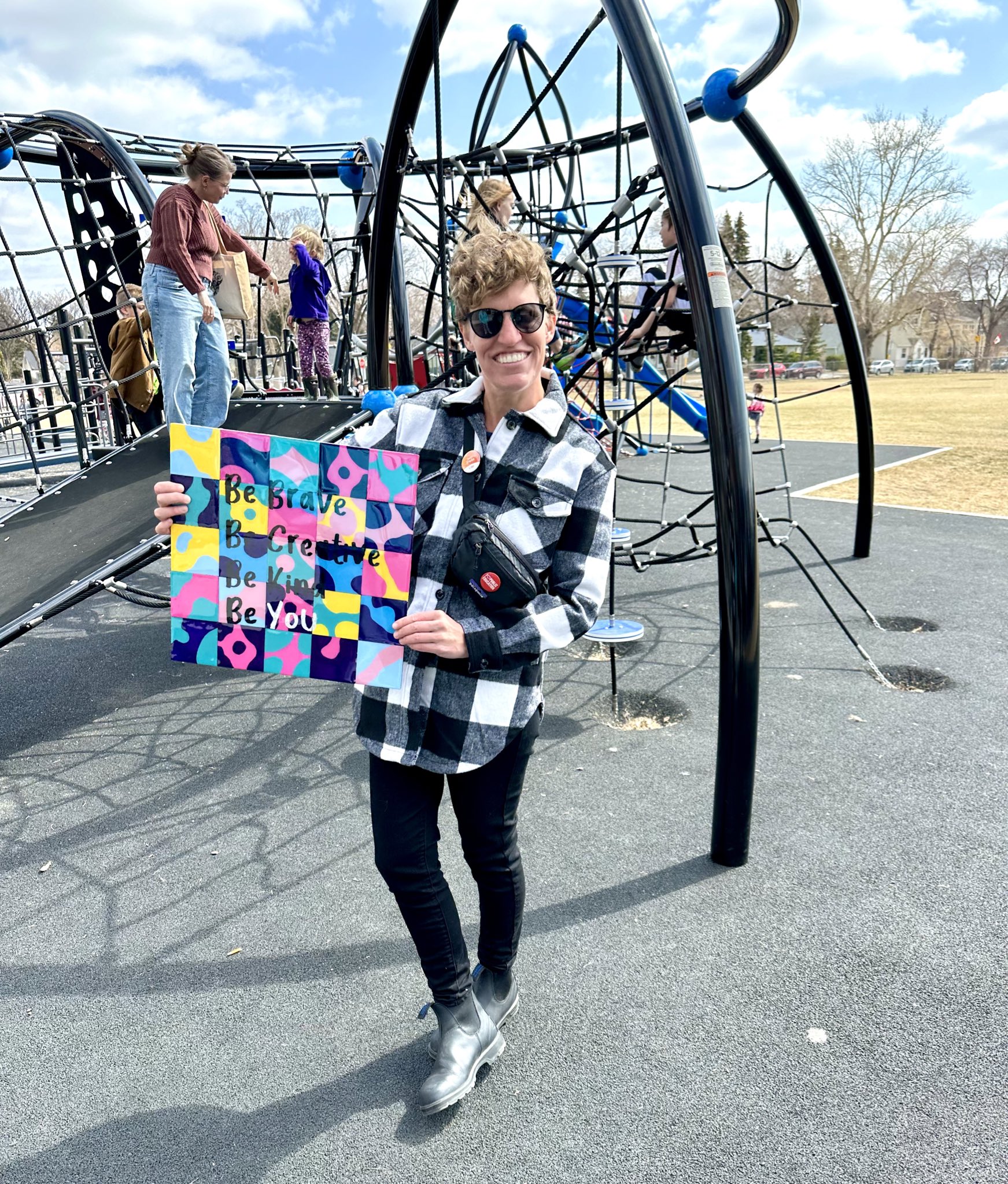 Janis holds the art she bid on outside of Highlands School