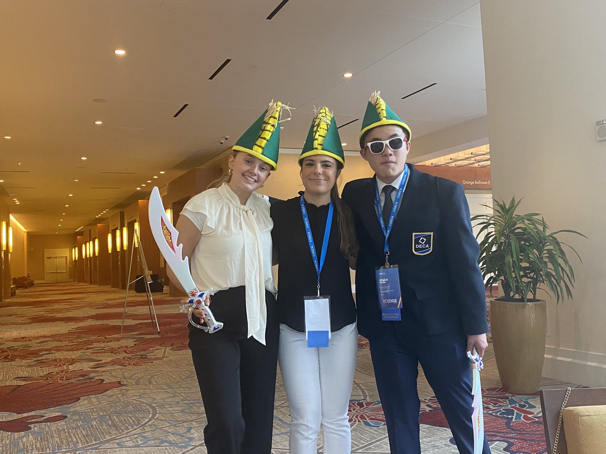 Just a couple of DECA ICDC competitors wearing corn hats and wielding swords.