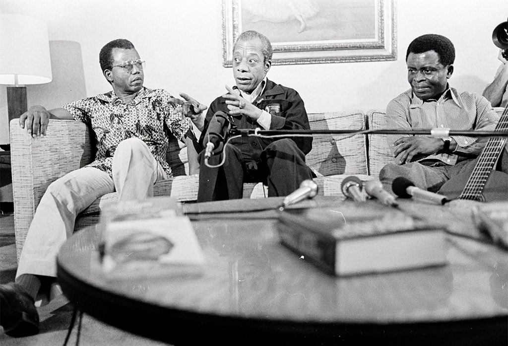 sunujournal's tweet photo. Three literary figures, from left to right: Nigerian novelist, poet + critic, Chinua Achebe; American novelist, essayist, playwright + orator, James Baldwin; Cameroonian writer, musician + composer Francis Bebey. (cont’d) https://t.co/K2ZSFCx7Wi