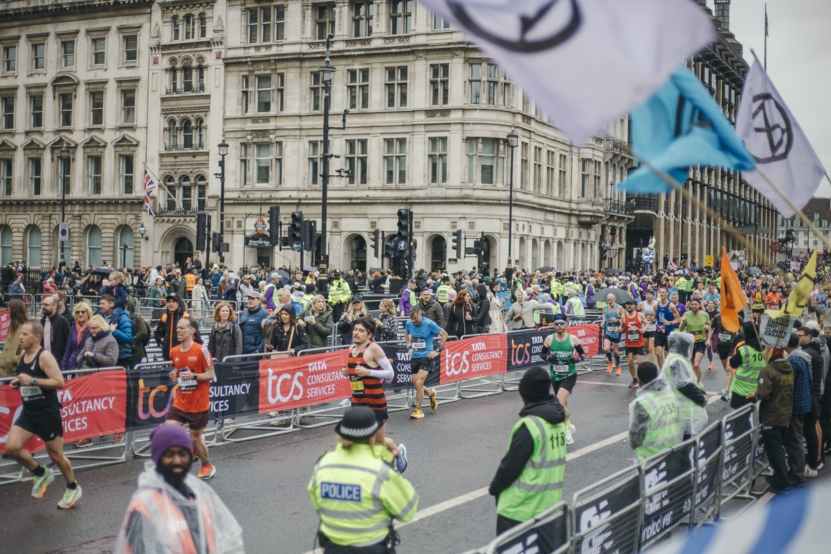 XRebellionUK's tweet photo. 🧵Today, thousands of people from different organisations returned to Westminster for #TheBigOne to support the #LondonMarathon, handing out leaflets to spectators and cheering on the runners. We are #RunningOutOfTime to act, but we are making ourselves impossible to ignore. https://t.co/L0EJ00kE6R