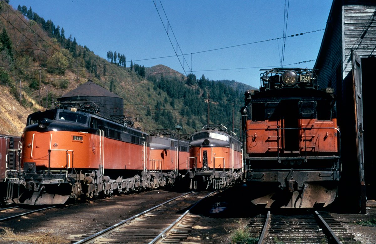 americanrails's tweet photo. Milwaukee Road "Little Joes" and boxcabs at the engine terminal in Avery, Idaho; September, 1970.  The small town was located at the western end of the railroad's eastern segment of its Pacific Extension electrification.

There was a small yard and maintenance facility located here, as well as substation #14.  After the line was abandoned, the Potlatch Corporation, a wood products company, found some of the Milwaukee's lines in northern Idaho useful for its timber and logging operations.

In all, it purchased the main line between Plummer Junction and Avery, 64 miles, as well as most of the Elk River Branch between St. Maries and Bovill, 52 miles. It chartered the St. Maries River Railroad which began operations on May 23, 1980, moving raw logs from Avery and Bovill, to the Regelus Mill near St. Maries.

The U.S. Forest Service condemned the right-of-way between St. Maries and Avery in 1986, 45 miles, to build what is today the St. Joe River Road Highway. 
 Today, the Milwaukee Road's depot in Avery is preserved.

https://t.co/KX4bRWbTFA