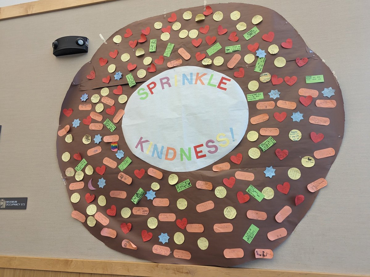 bhavanar's tweet photo. Our elementary school made this amazing donut with sprinkles during kindness week. Some of us parents made the brown donut and the yummy center - biggest donut ever! Kids put sprinkles talking about a kind thing they had done. #kindness #kindness_week #Kindergarten #Donuts https://t.co/9GJCTlISFo