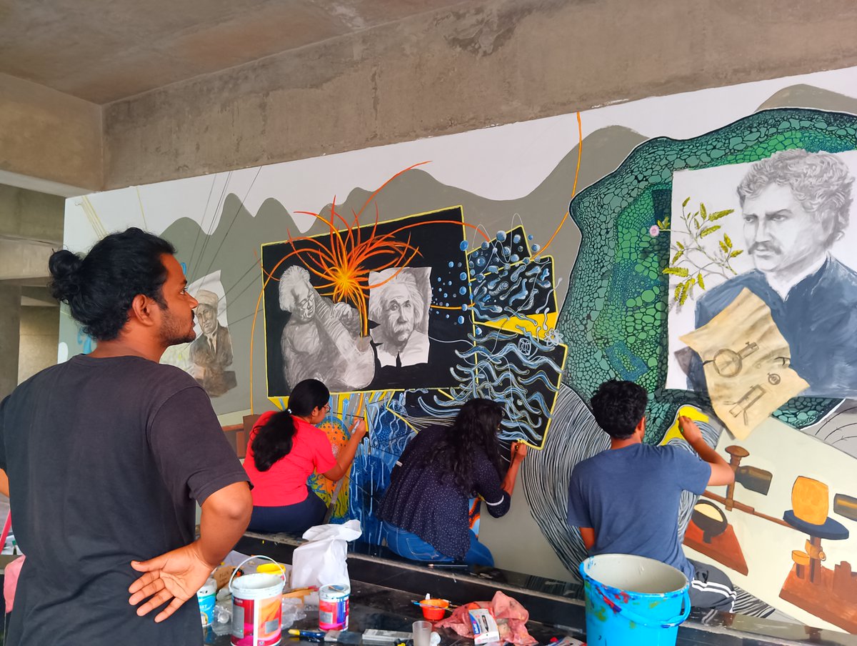 iitgn's tweet photo. IITGN  features a new mural in the campus depicting the birth of modern Physics in colonial India. Conceptualized and designed by Argha Manna, Artist-in-Residence, @HSSiitgn, it was painted by him, artist Suman Chowdhury, and IITGN’s faculty members and students.
#MuralAtIITGN https://t.co/VnKK3mf4iQ
