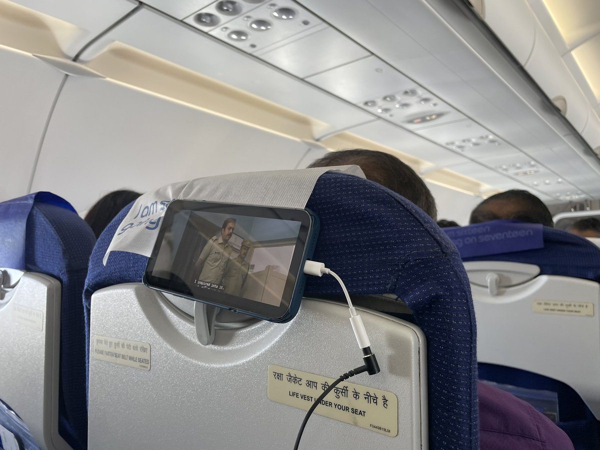shinexavier's tweet photo. Though this customer innovated and got his comfort angle for entertainment on his phone, it may not be a bad idea to have a cost effective and simple provision for anchoring one’s smartphone behind the seat. A comfortable BYOE (Bring your own entertainment) on the GO!#goIndigo https://t.co/Q16sbbzDQk