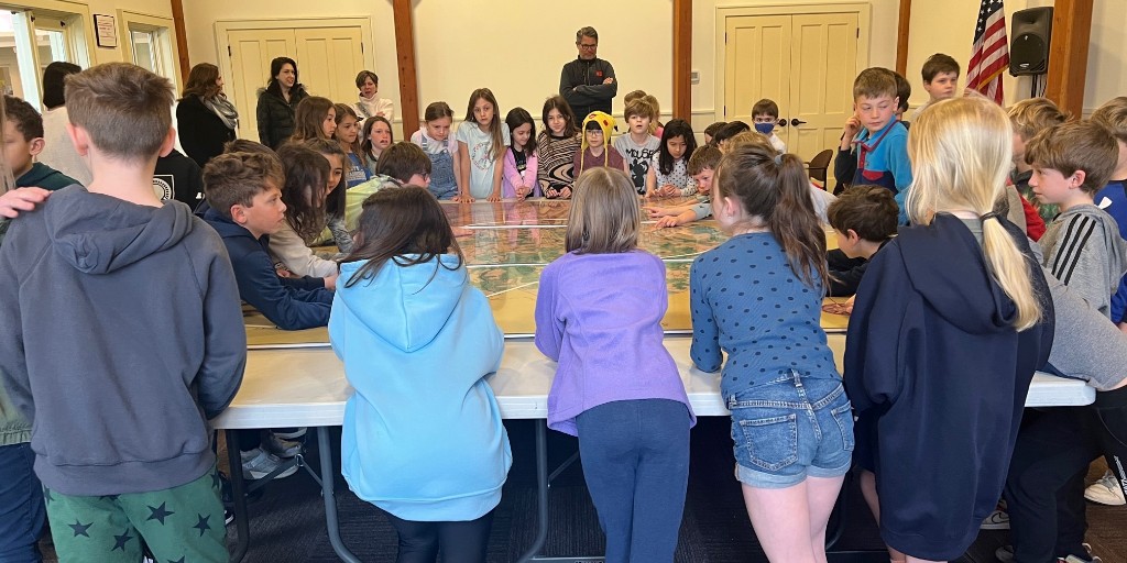 fairfieldmuseum's tweet photo. K-12 field trips are in full swing! Here are 3rd graders from Riverfield Elementary exploring the history of Fairfield through maps &amp; artifacts from our collections &amp; making corn husk dolls after learning about Native American culture. Thank you @BankWellCT for your sponsorship. https://t.co/0zq1CpjDvT