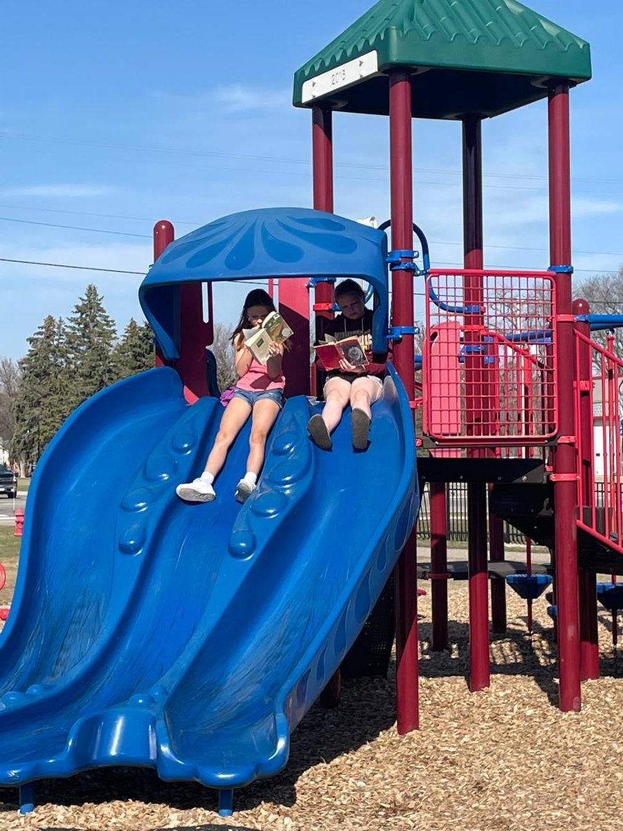 Minnesotans take every opportunity to enjoy nice weather...when we can - pictured are a few of our 5th graders silent reading outside on Cardinal Island. #AES #isd876 #Reading #CardinalIsland #outdoors #spring