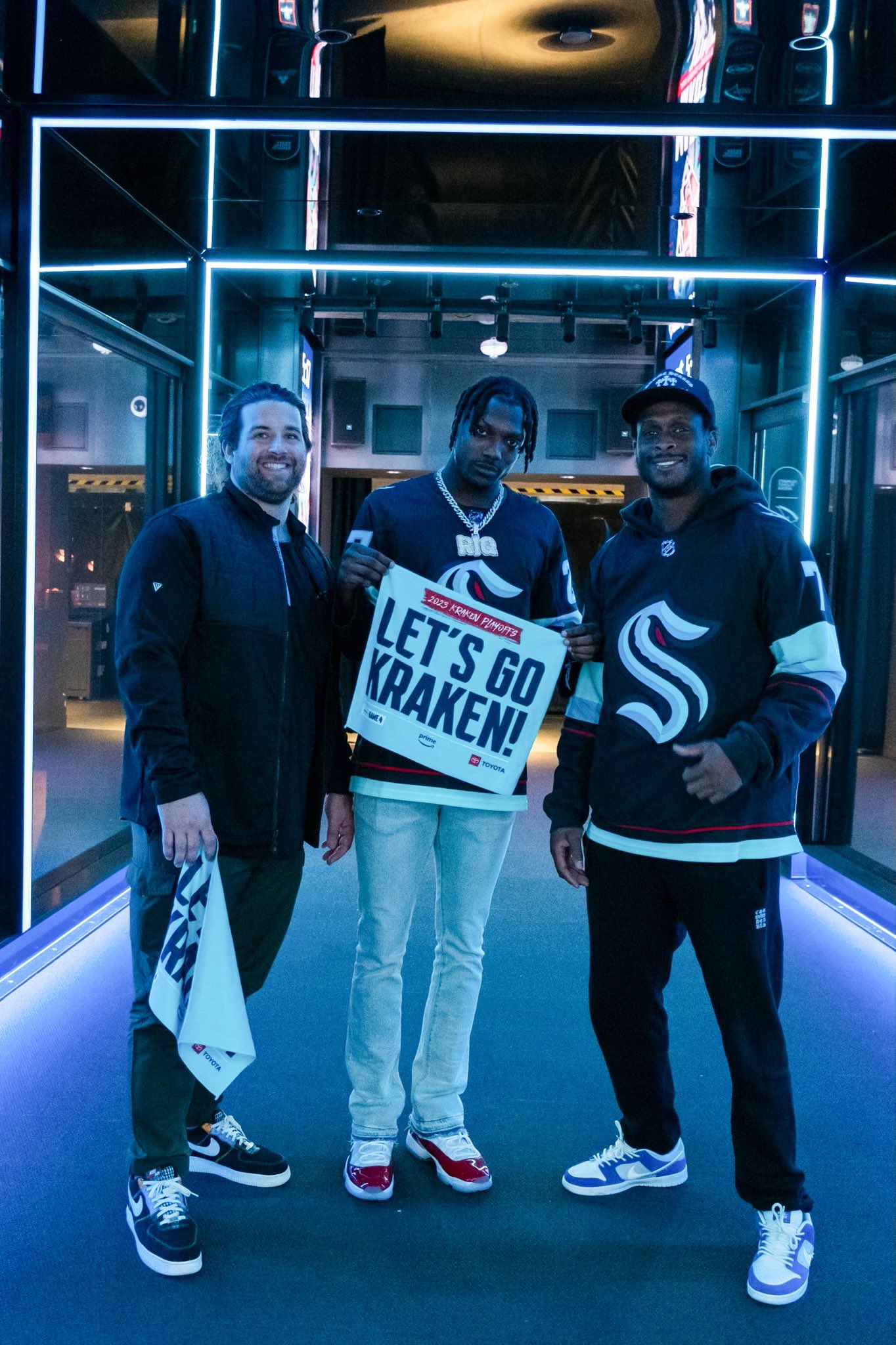Seahawks Joey hunt, Tariq woolen and geno smith at kraken game