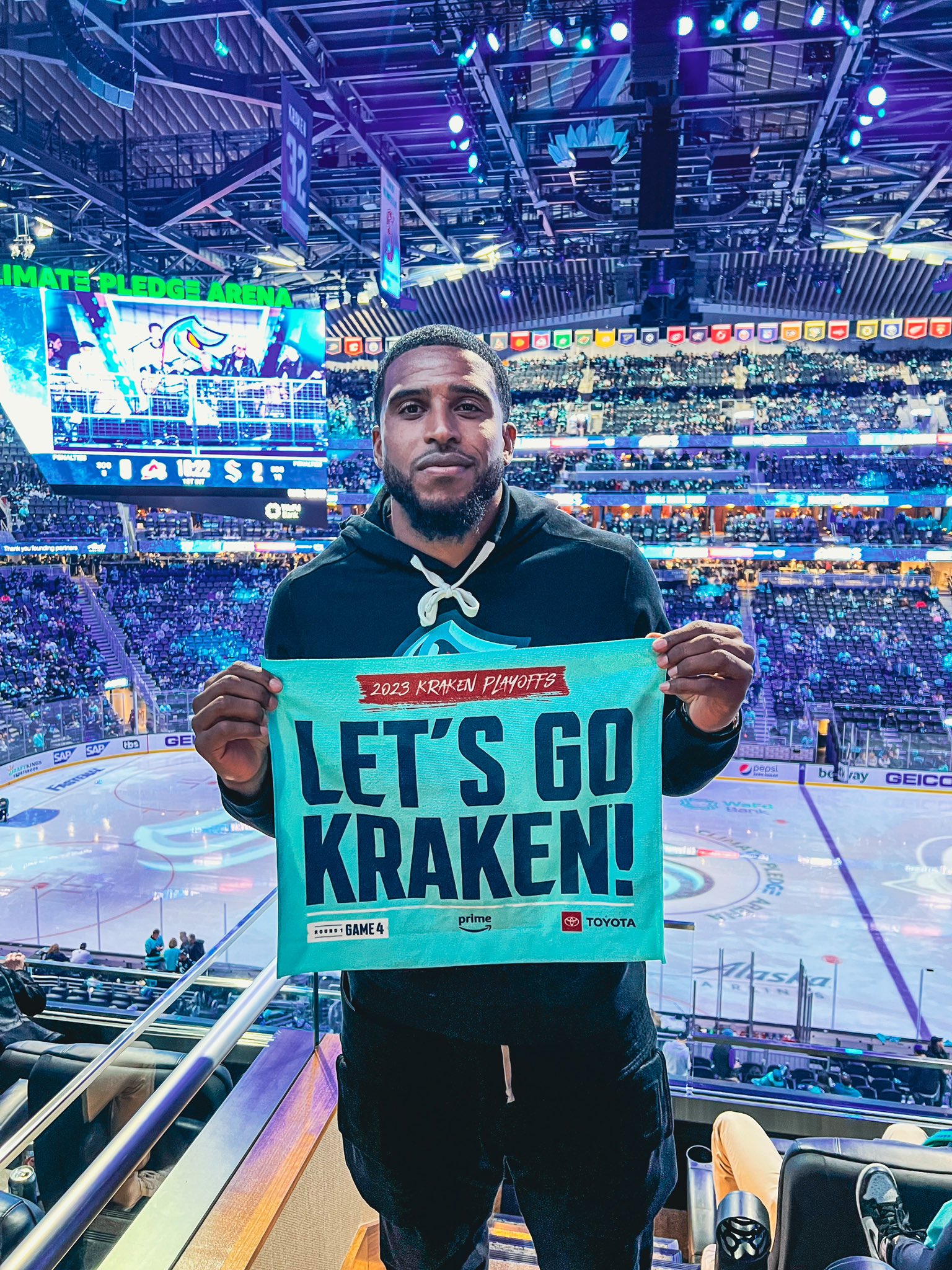  Bobby Wagner posing at kraken game with rally towel