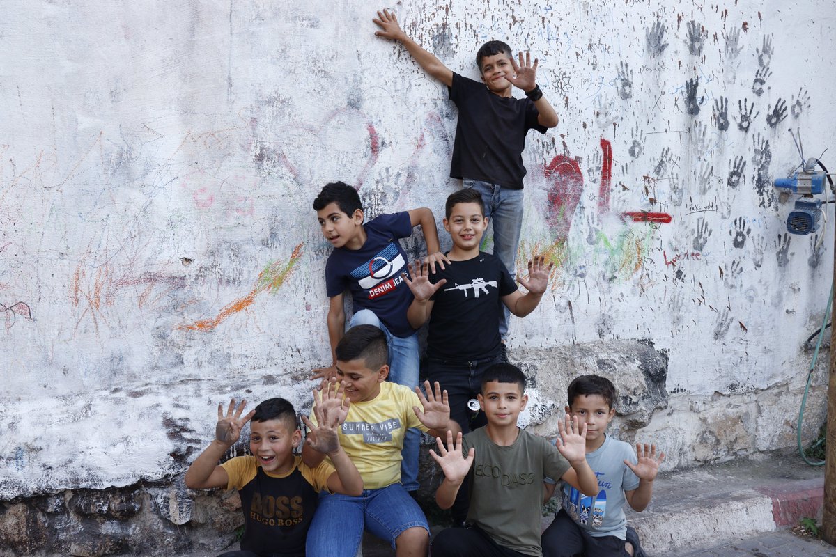 'Colors of Resilience: Palestinian Children Find Joy and Release in Painting Their Hands on a Wall, a Small Act of Defiance and Expression Amidst the Stress of Occupation.' #Palestine #ChildrenOfPalestine #Resilience #Occupation #Hope