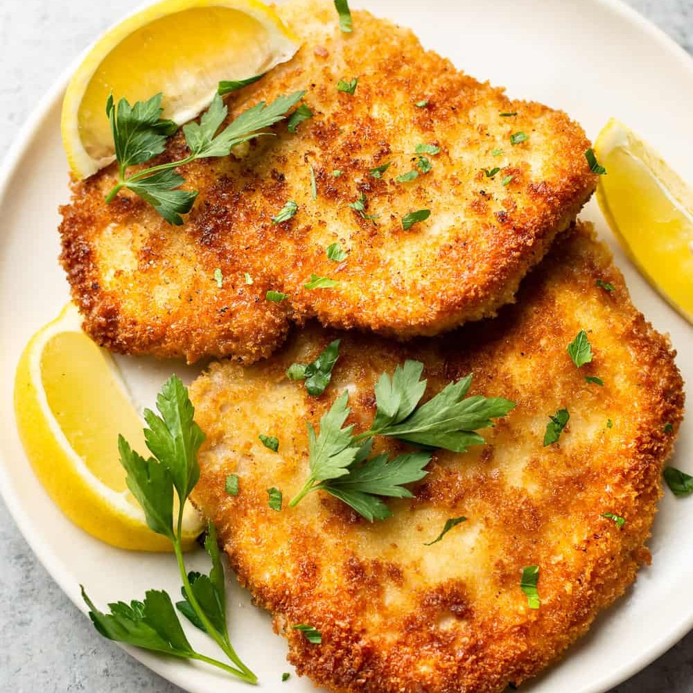 Pork Schnitzels are breaded and fried to perfection for an easy and delicious meal the whole family will love. Total cozy comfort food!

therecipecritic.com/pork-schnitzel/