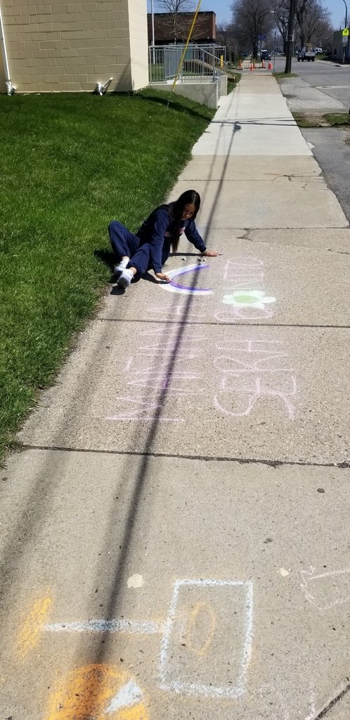 Ms. Hudson's art class enjoys a sunny day, creating some cool sidewalk chalk art outside!