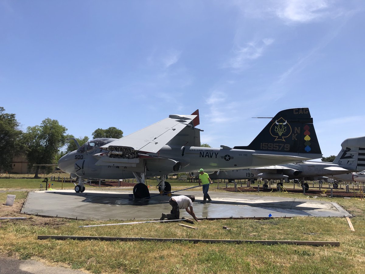 CastleAirMuseum's tweet photo. Museum staff Board Member Parsley and volunteers finishing the concrete work around the A-6 Intruder in preparation for the dedication on Open Cockpit Day May 6. https://t.co/5ufUiz4qky