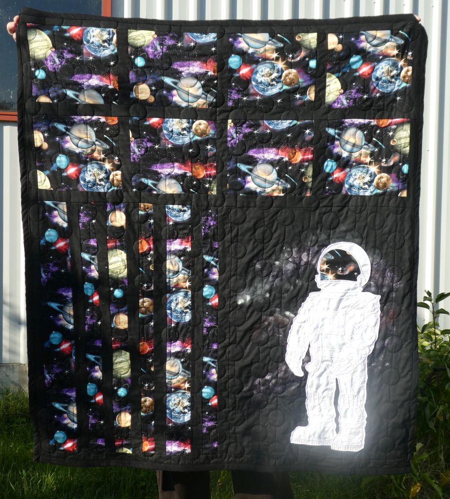 SusanBluerobot's tweet photo. My  spacequilt. I designed the embroidered spaceman and embroidered it  using 7 hooping on my big brother hoop. Then pieced the topping and  quilted the quilt before adding the spaceman https://t.co/7gU5dTdbFn