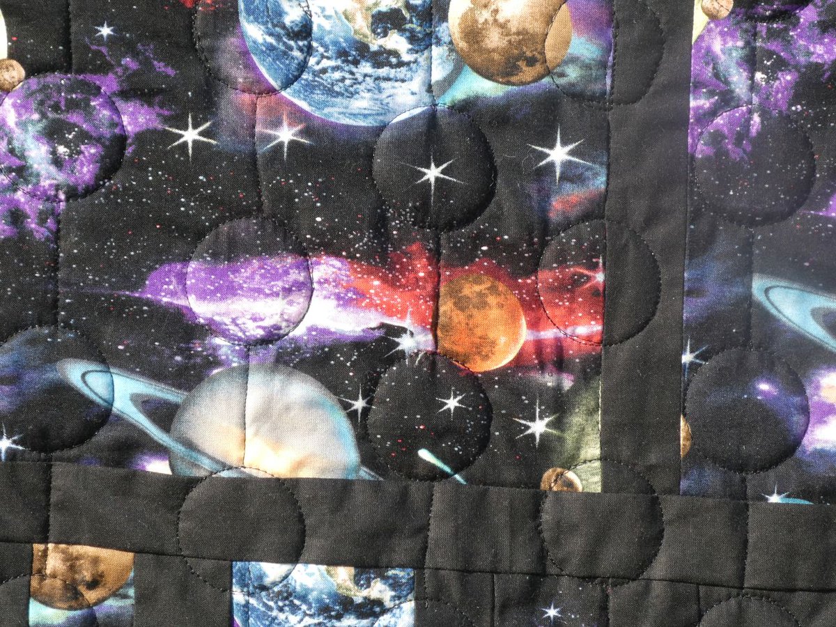 My  spacequilt. I designed the embroidered spaceman and embroidered it  using 7 hooping on my big brother hoop. Then pieced the topping and  quilted the quilt before adding the spaceman