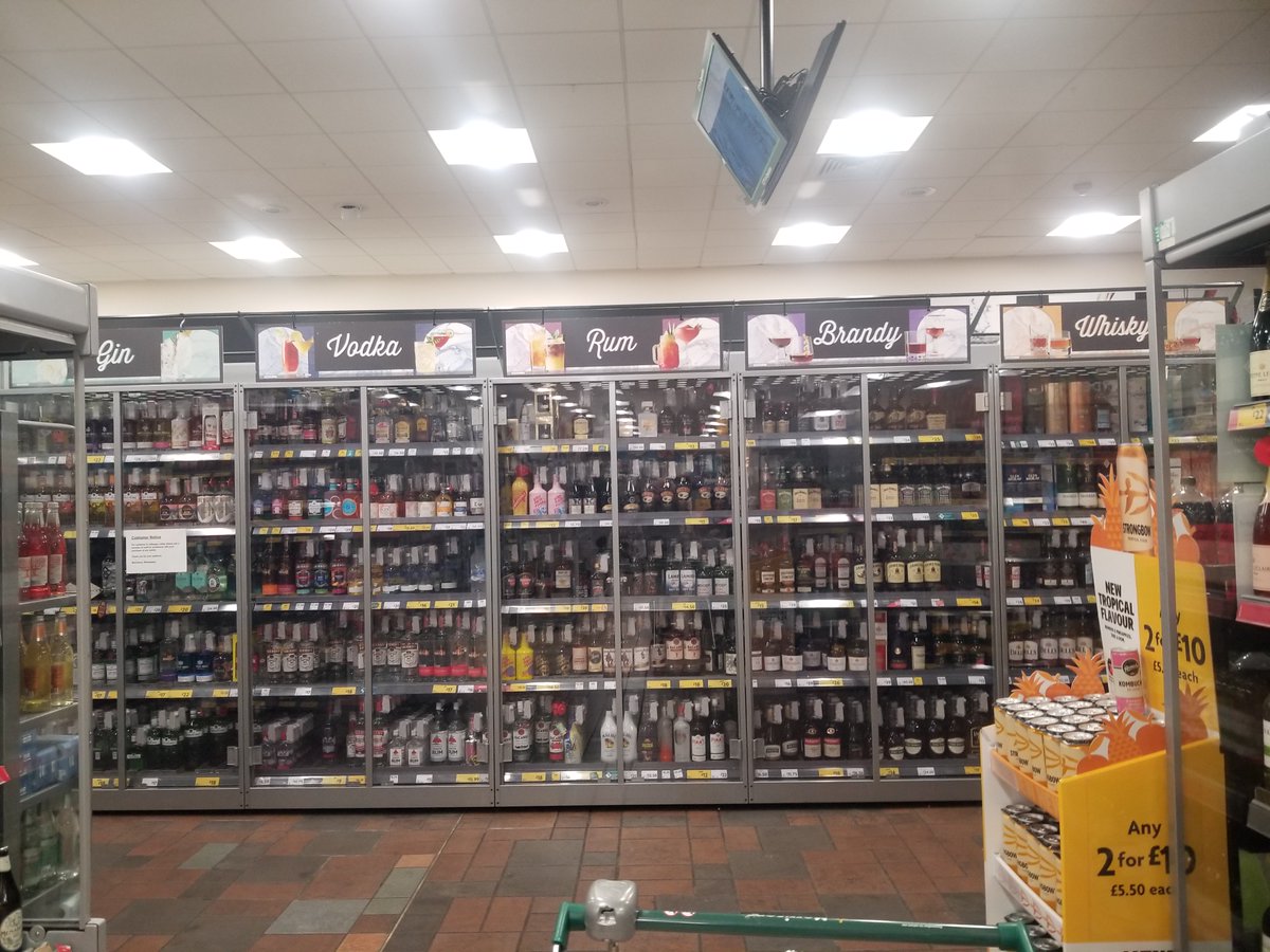 _Chris_Magee_'s tweet photo. Feeling blessed to have witnessed the worst business decision of 2023 in @Morrisons Wimbledon! They've locked up the booze and, if you're a shopper, you have to get an adult to help add it to your basket before queueing. Pioneering the world's first inconvenience store. https://t.co/FXEfvfElLm