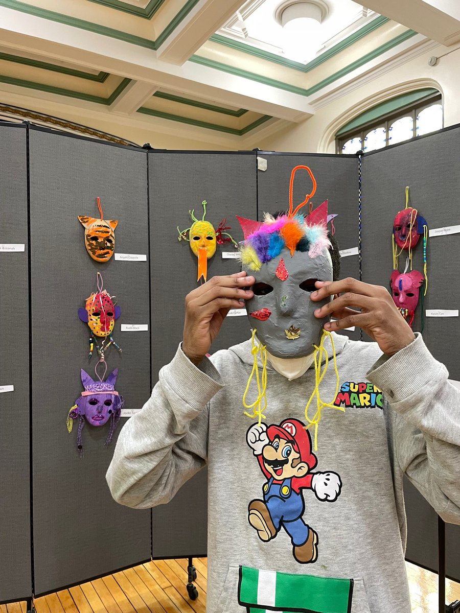 P77K artists pose with school Principal Mrs. Ebony Russell and show off their talent in an art exhibition celebrating Masks Around The World for this year's schoolwide CR-SE Festival. #equity #CulturalEvents #education #Brooklyn #artist