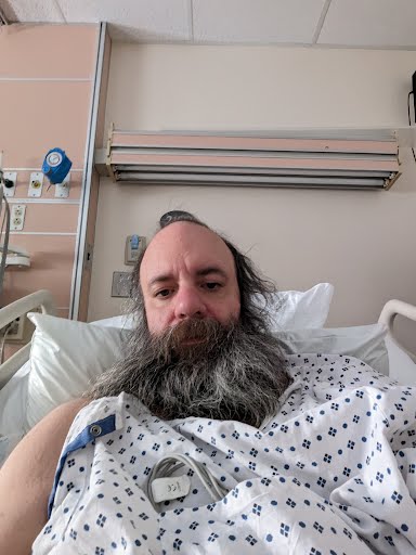 DavidSchenet's tweet photo. I haven't posted in a long time, for numerous reasons, but here's at least one important update. 
1. Probably the only selfie I'll ever post.
2. 2x IVs = twice the fun
3. They keep my walker way over /there/ so I can't use it unsupervised.
4. The general situation. https://t.co/2L7RhcQyhZ