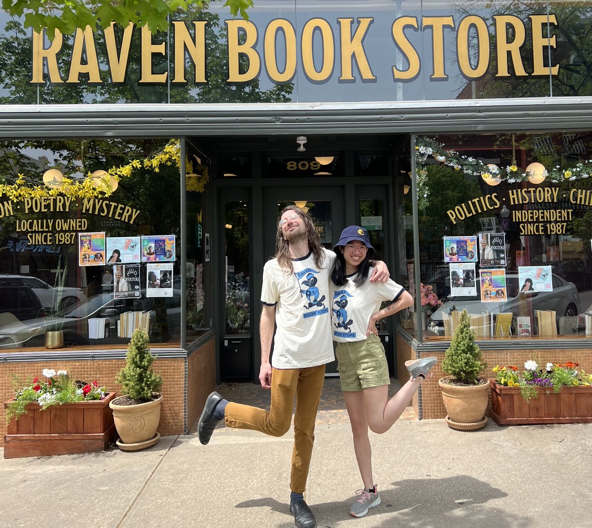 ravenbookstore's tweet image. Saturday is #IndependentBookstoreDay! You know what that means: new Raven shirts!

Here, Chris and Lily model this year's model, which features a dapper little mascot guy (designed by @QuietVessel) printed on a soft ringer tee right here in #LFK at Blue Collar Press!