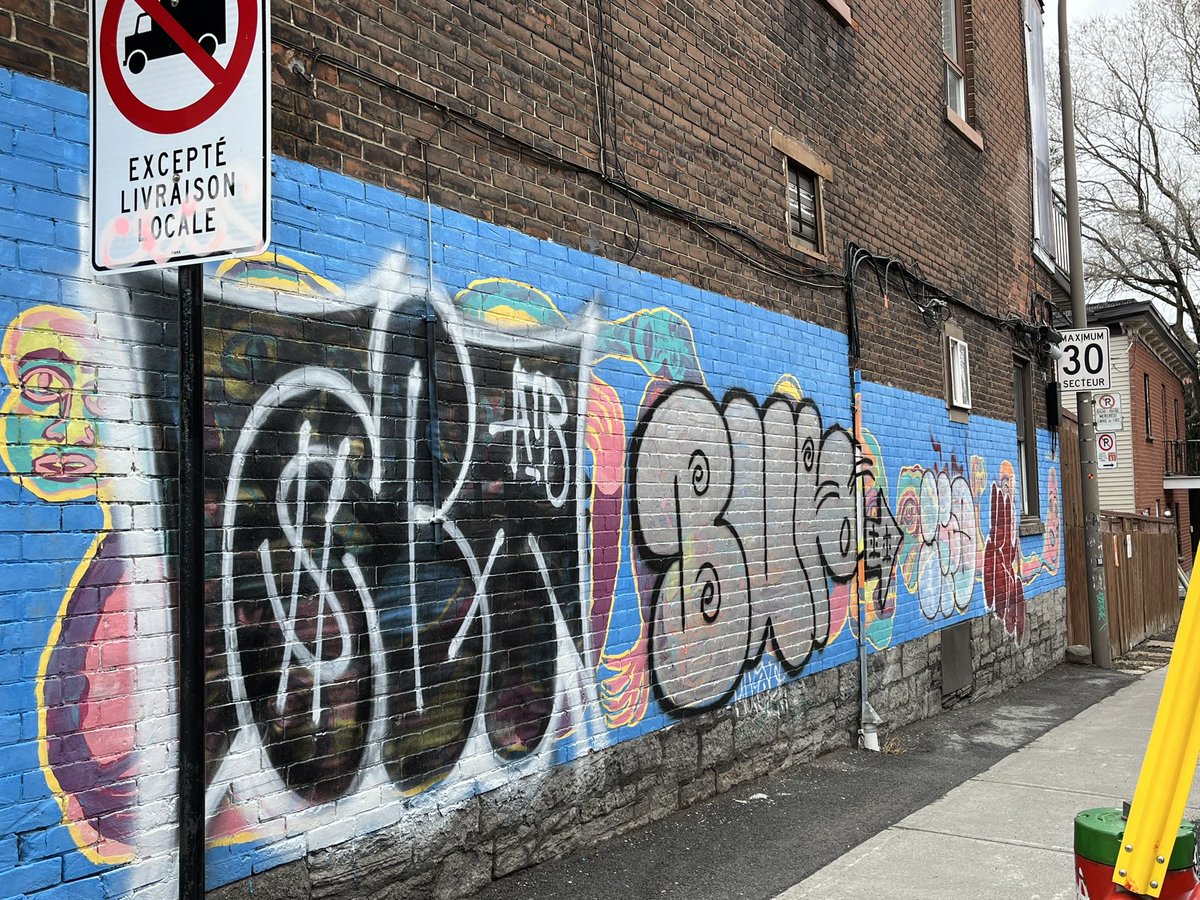 ToulasTake's tweet photo. Taggers seem to have really had a field day in Saint-Henri lately. I’ve never seen this much graffiti in my neighbourhood. I love urban art but tagging irks me. It’s so devoid of talent. It’s just vandalism. It especially annoys me when taggers destroy gorgeous murals. 😡 https://t.co/ElBu63cCoo