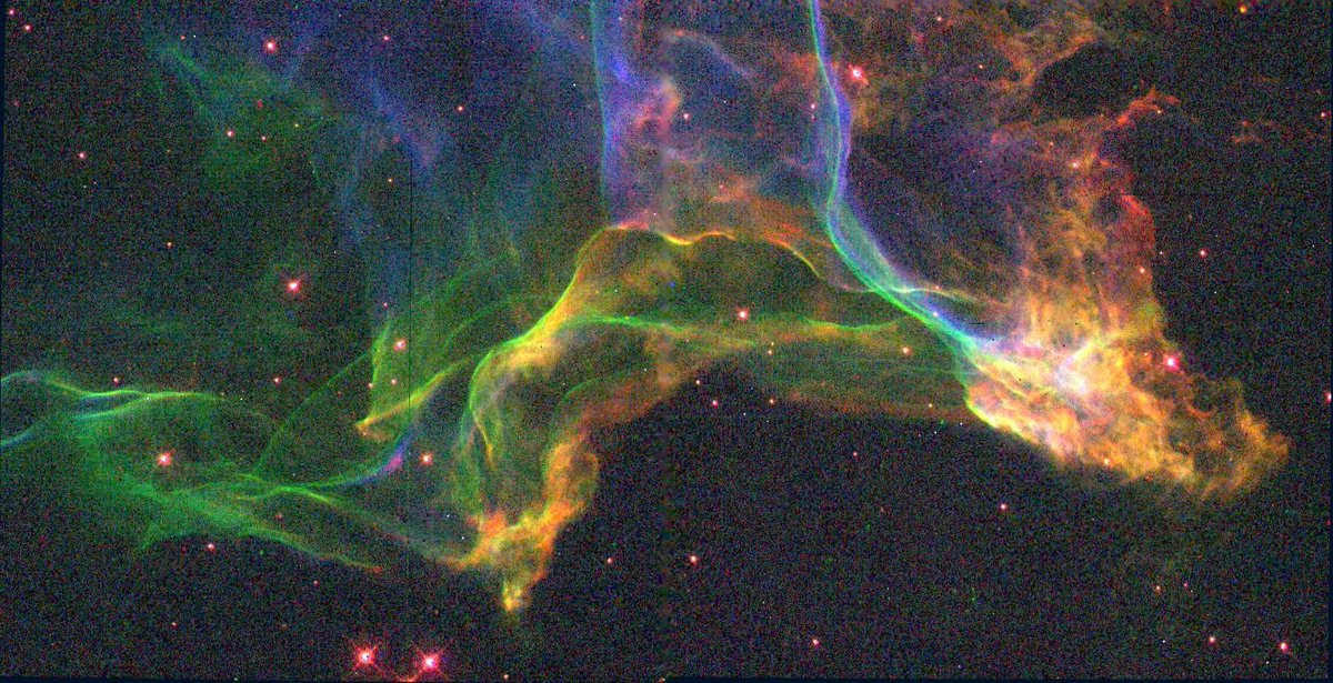 HubbleTelescope's tweet photo. These loping trails of gas were emitted by a supernova 15,000 years ago. (Trace their motion from right to left.)

What caused these colorful tendrils to appear? As the blast wave expanded, it encountered dense interstellar gas. The collision lit up the scene. 

Credit: NASA, ESA https://t.co/qob1eRW7th