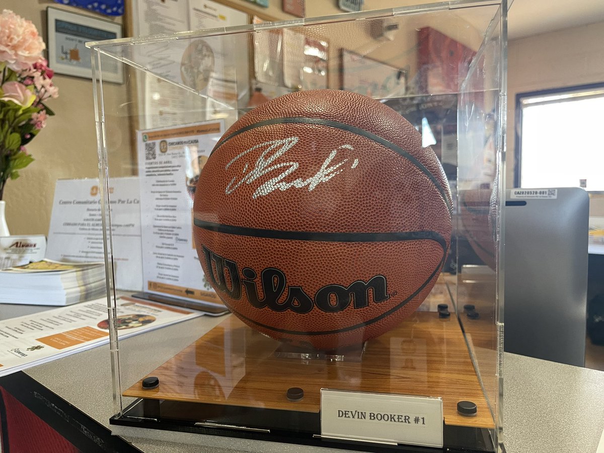 Our signed #DBook basketball is looking very guapo in its new display case! We’ll be displaying it in the community center lobby for all to enjoy. We want to help inspire our teen athletes as they prepare for Fridays bball tournament on our new court! <a href="/Suns/">Phoenix Suns</a> <a href="/DevinBook/">Book</a> #basketball