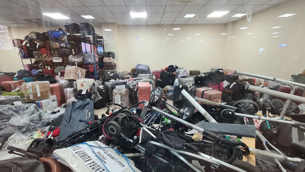 DrNi_Run's tweet photo. Its a chaos @TIAKTM. Baggages on the floor and one whole room full of unclaimed luggages and kids stroller. Have they even informed passenger regarding the luggages that has been kept in room? https://t.co/Ca4QBHHUFB