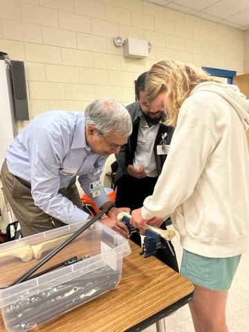 AtriumMSKI's tweet photo. Drs. Holly Pilson &amp; Artina Dawkins w/ Atrium Health Wake Forest Baptist partnered w/ @AtriumMSKI and @CMC_OrthoRes to host the ODDySSEY Program, which included a Grand Rounds presentation &amp; surgical skills simulation program with students at Sedgefield Middle School. Great work! https://t.co/NmvhBRQ17T