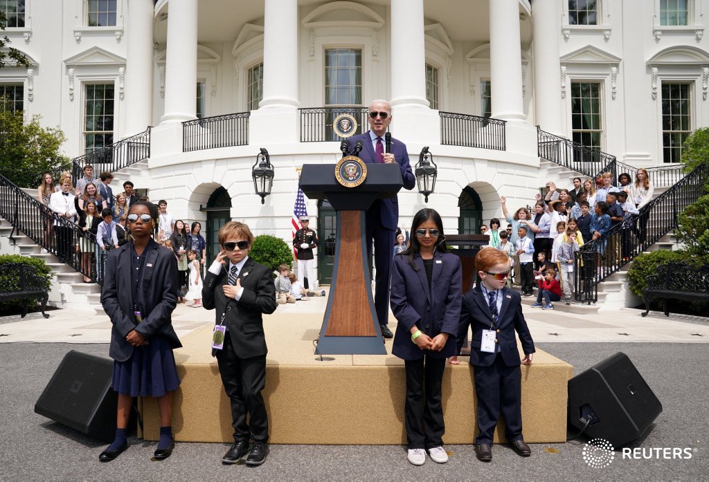 Children dressed as Secret Service agents keep watch as U.S. President Joe Biden speaks at a "Take Your Child to Work Day" event at the White House in Washington. Photo by Kevin Lamarque