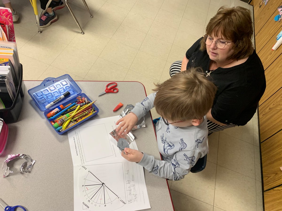 raypecschools's tweet photo. In an elementary school classroom today, School Board President Ruth Johnson watches while a student works on an assignment about directions & patterns of the moon. Johnson accompanied Superintendent Dr. Mike Slagle on some classroom visits today. #forwardandbetter https://t.co/PD54grqEy5