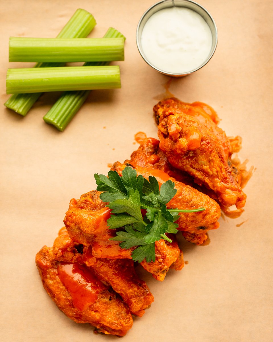 These jumbo chicken wings are so big they may fly away! Get ready for a tasty mess with our Buffalo sauce. 🍗🔥