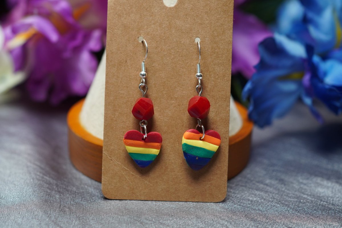 Add some color to your jewelry collection with our handmade clay rainbow earrings! 🔴💫 You'll love the unique style created by our talented artist, who is proudly part of the LGBTQ+ community. These earrings can be worn with pride. #earrings  #rainbow #redbeads #LGBTQ #pride