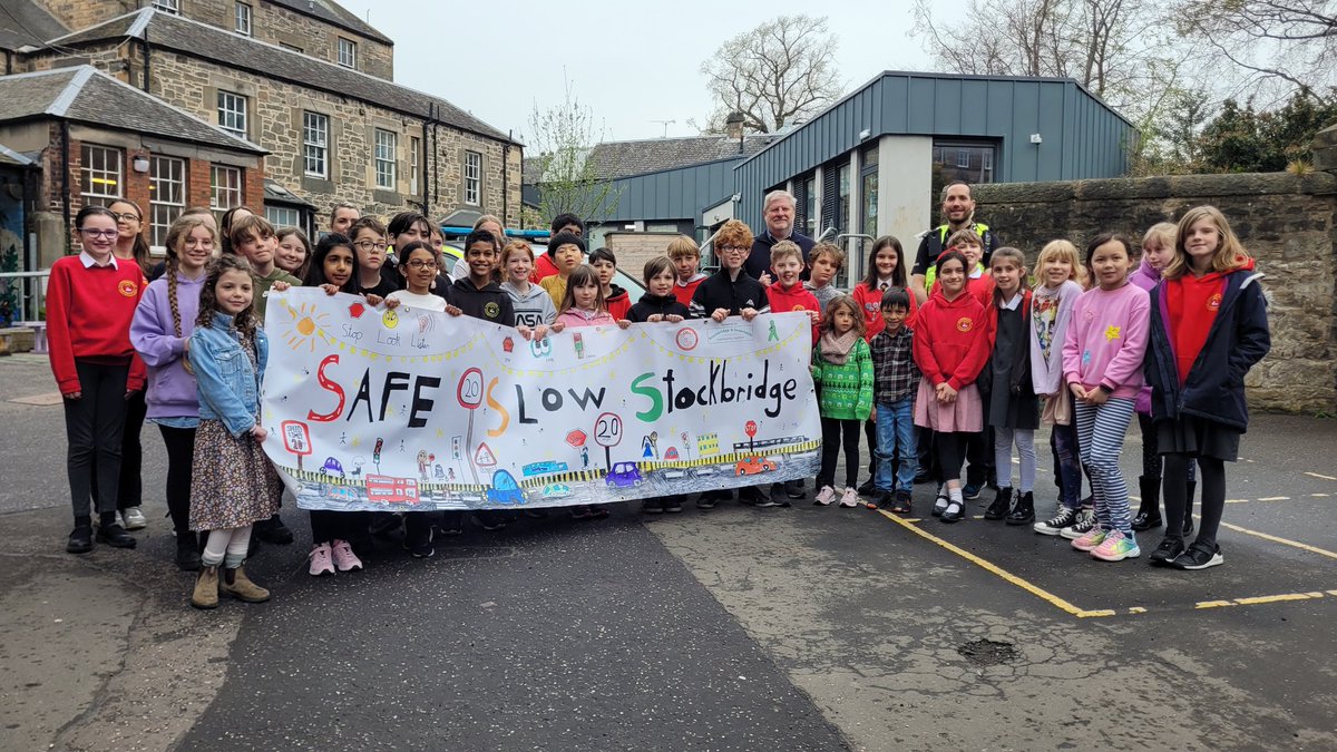EdiGuide's tweet photo. Stockbridge Primary kids launch safety campaign. Plus Willie the lollipop man (for 5 ys) shows a little present from one of the pupils. #safeslowstockbridge https://t.co/yGDXeiF6hr