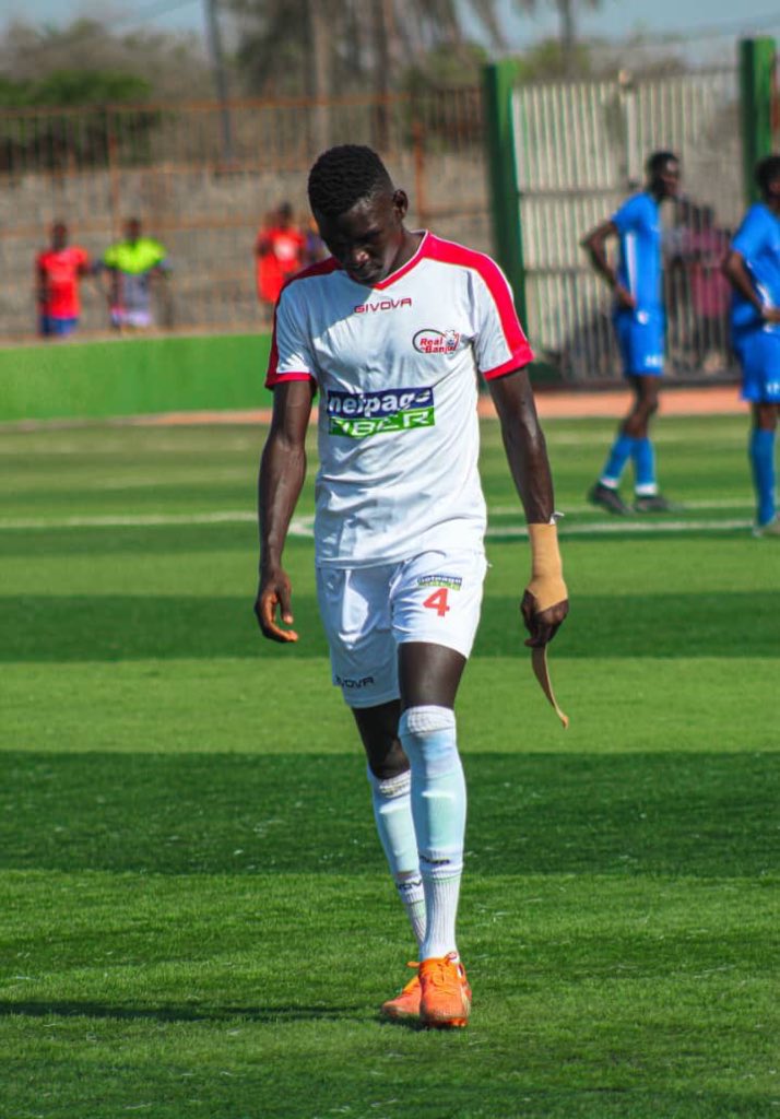 RealDeBanjulFC's tweet photo. Keep your head up, Essa ✊🏼.

We are with you and will surely miss your personality, heroic performance and hard work in the next two matches. 

We can’t wait to have you back, lion heart.

#RDB #EssaJallow #Real4Real #Real4Life #CityBoys #RealDeBanjul #NetPageFIBER https://t.co/YQSN9lUG58