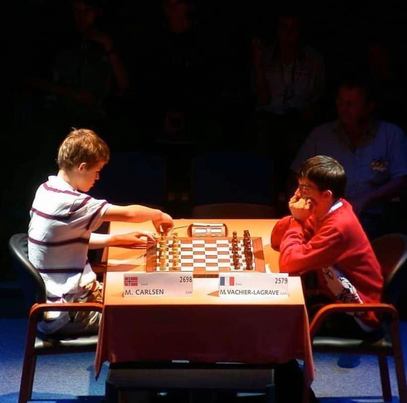 Ruhichess's tweet photo. Legendary picture of Magnus Carlsen vs Maxime Vachier Lagrave from 6th Lausanne Young Masters 2005 💜

Both are 1990 born, Carlsen is younger by a month. 

( Photo credit unknown ) 
#Magnuscarlsen #Chess #Chesschapions https://t.co/W5trKY70wR