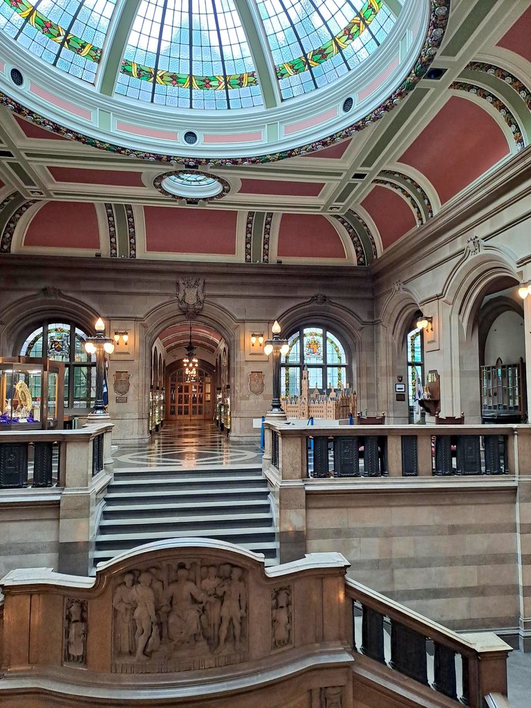 Civic entrance with a grand stone staircase and staines glass dome in ceiling/roof. 