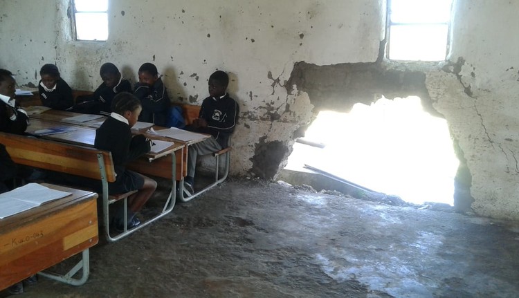 GroundUp_News's tweet photo. Eastern Cape learners shiver in collapsing mud classrooms despite contractor having been appointed to build prefab classrooms six years ago. https://t.co/Sa8ixzr4w7 https://t.co/BjCDFpq9CX