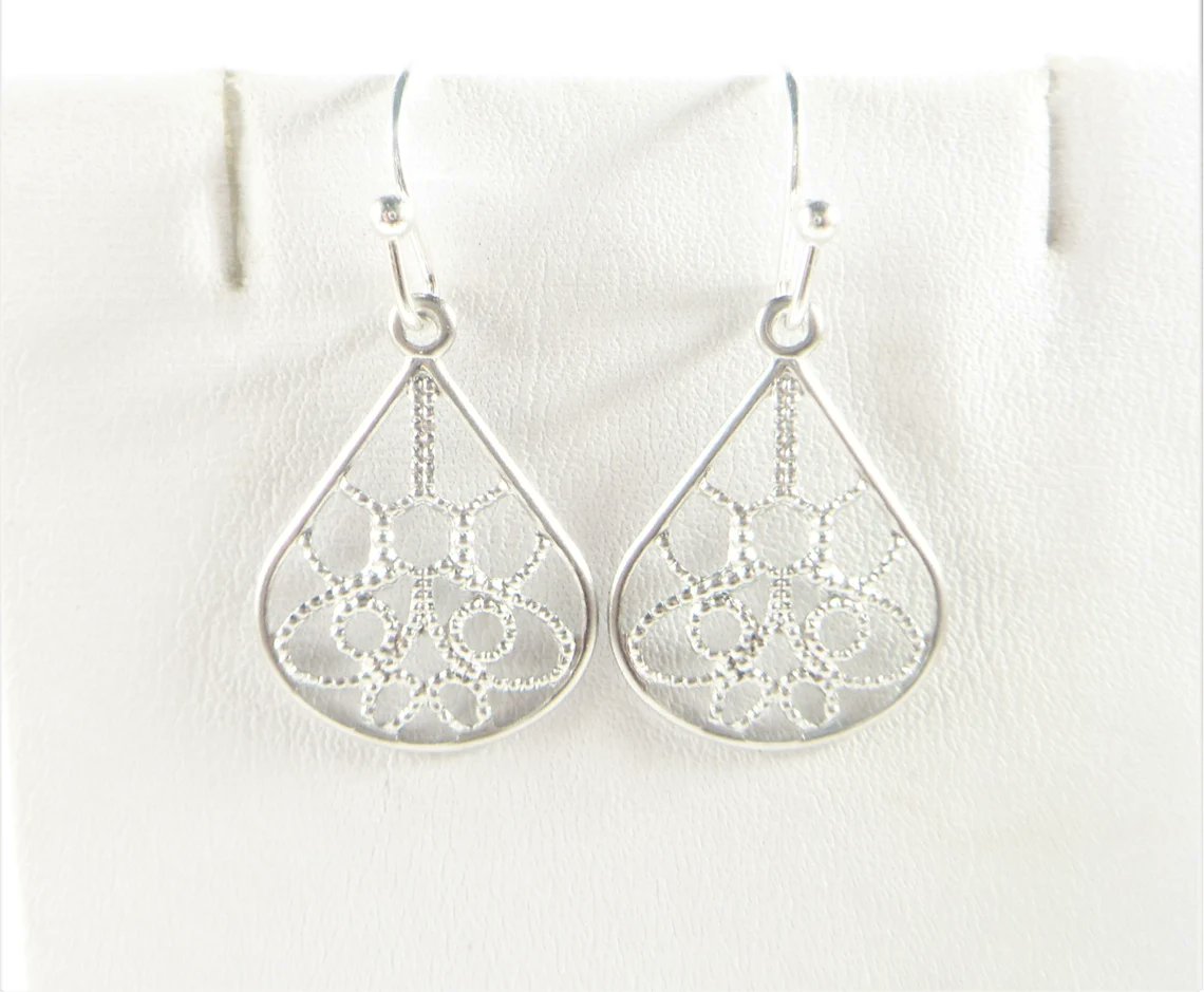 These teardrop earrings are created with small dainty teardrop charms and dangle 1 1/8 inches from top of silver plate ear wires. etsy.me/3CenSJi
