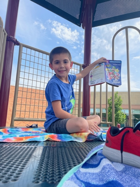 ElkhornPS_FR's tweet photo. The first graders in Mrs. Renken's class used their imagination and made the playground into a beach for Beach and Books day! #FireRidgeFalcons #EPSAchieves https://t.co/fXU1hoJU6n
