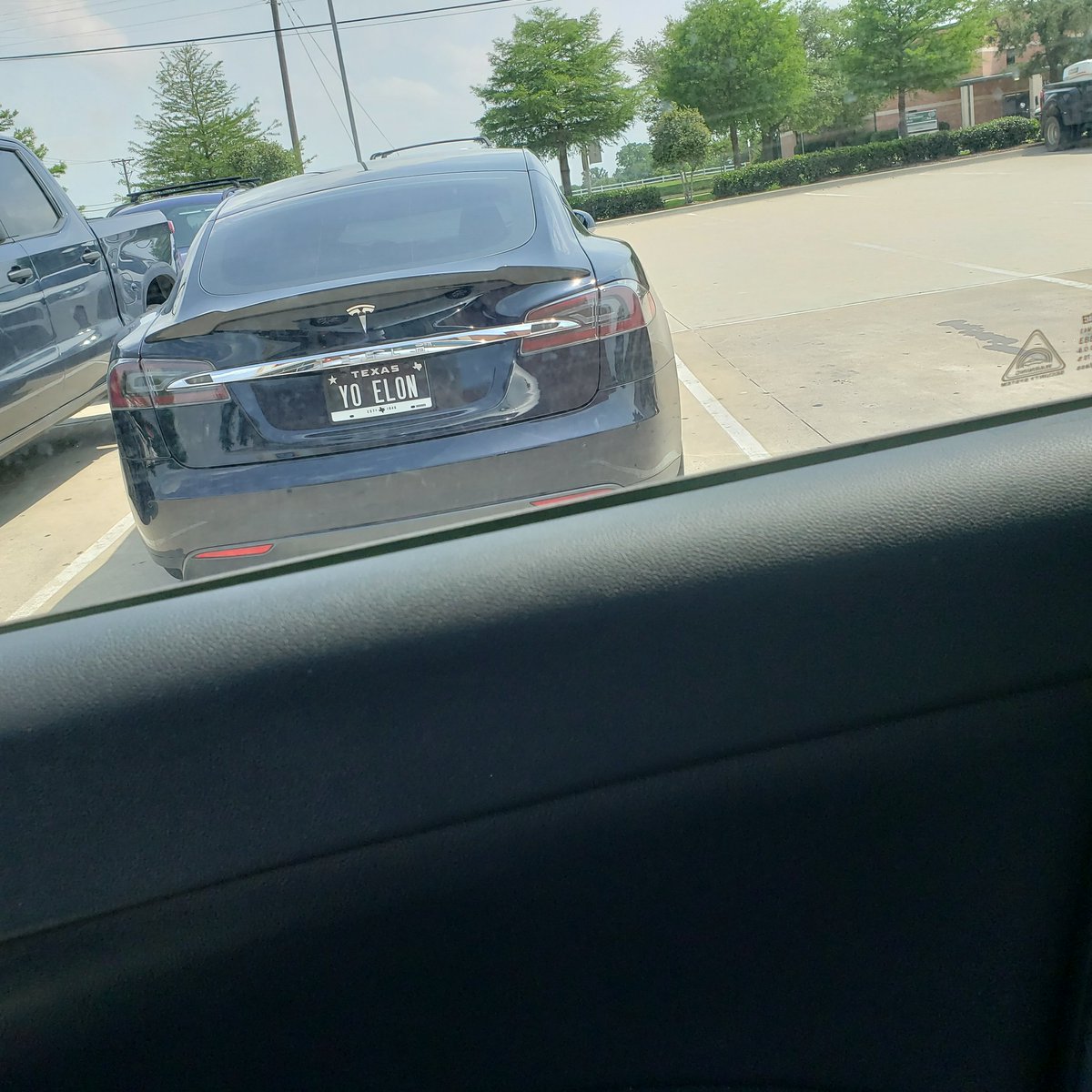 Breaie's tweet photo. Only in a TX Aldi parking lot will you see Yo Elon license plates on a Tesla https://t.co/3L5MlnB8EO